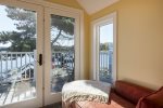 second floor reading area at the end of the hallway with a gas stove and ocean view balcony.